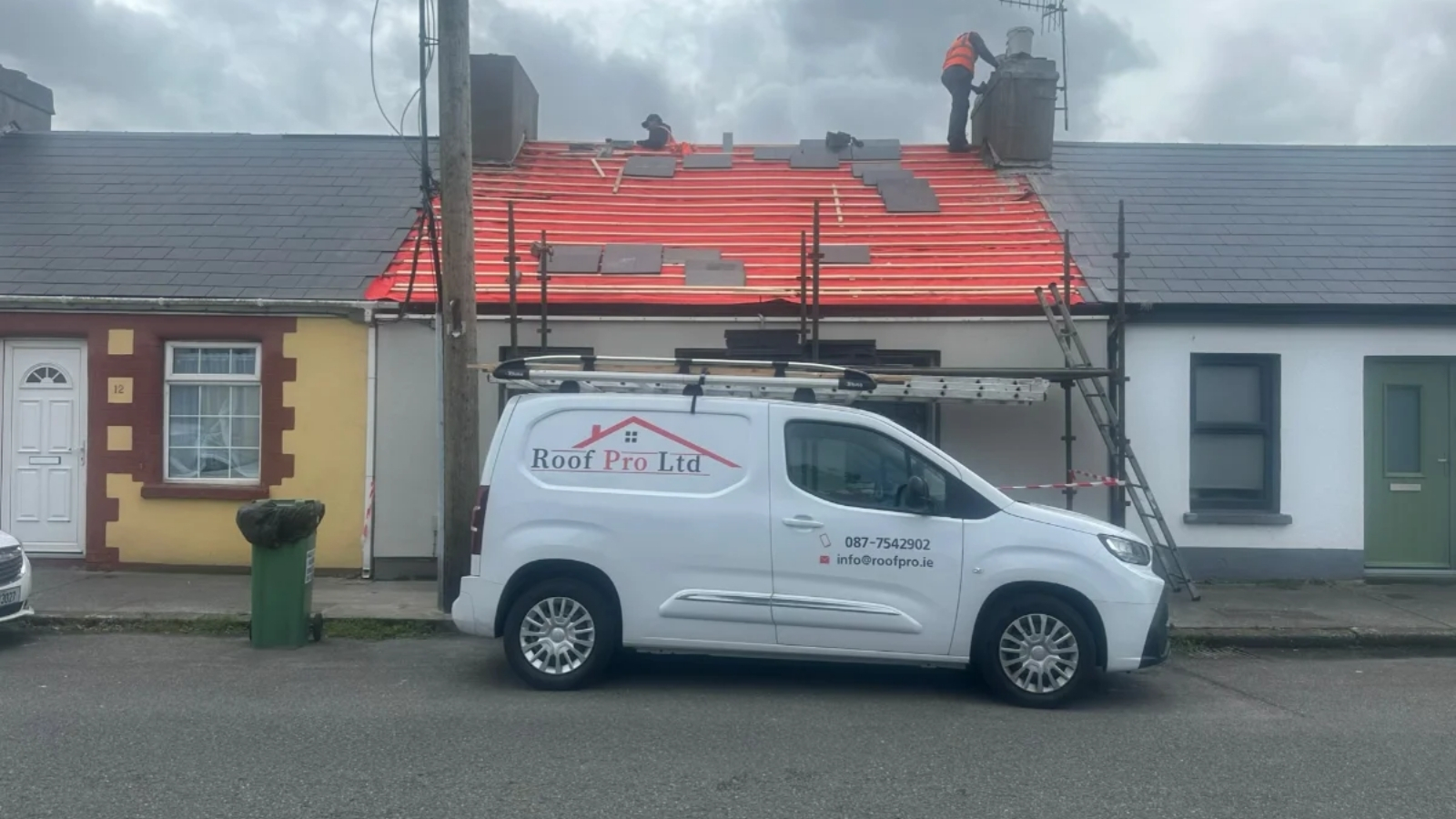 Roof Pro Ltd van outside a slate roof installation project in South Dublin