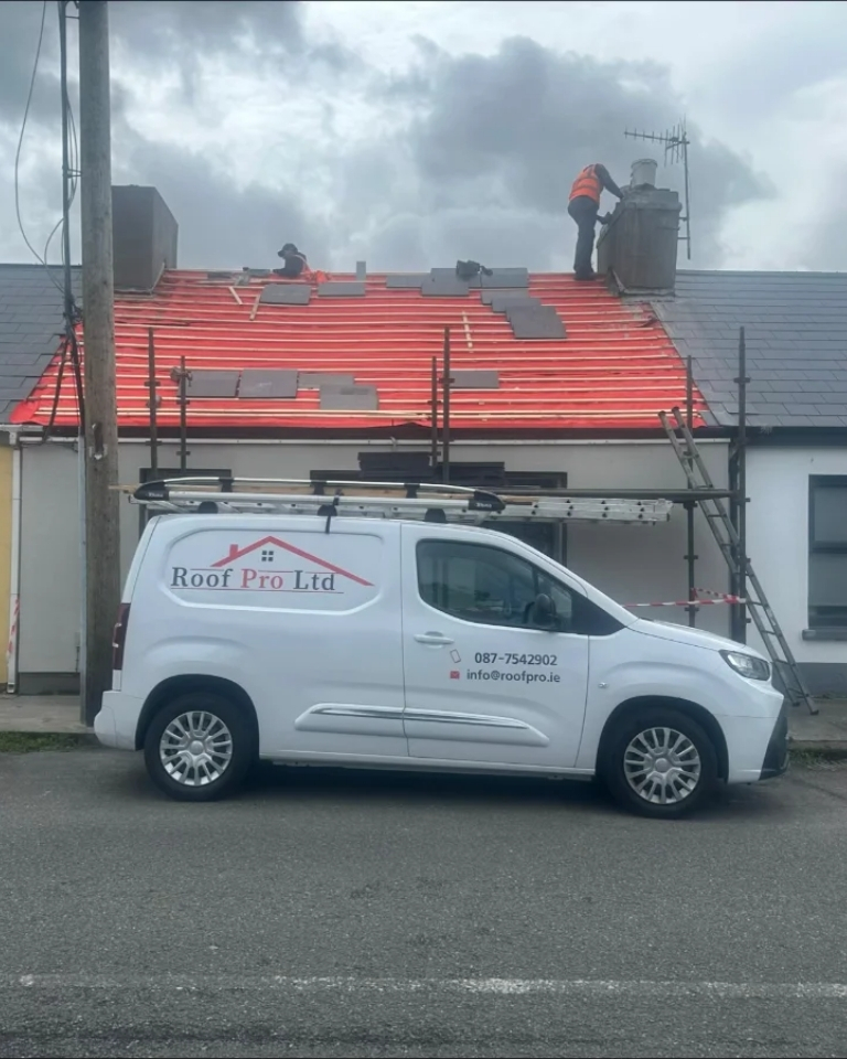 Roof Pro Ltd van outside a slate roof installation project in South Dublin